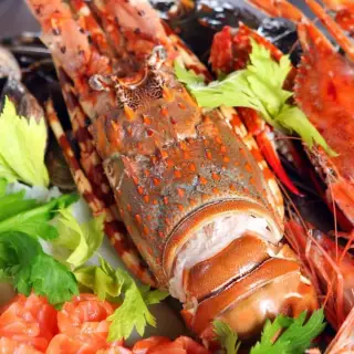 A mixed seafood platter with lobster, crab, shrimp and vegetables