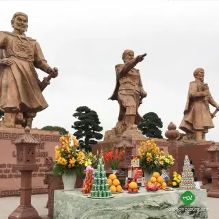 The three commander statues at Bach Dang Giang with offerings in the foreground