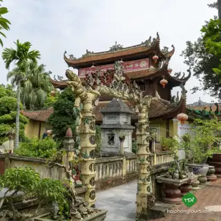 Three-tiered bell tower and dragon-carved gateway at Du Hang Pagoda in Hai Phong