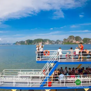 Passengers on the upper deck of a ferry between Cat Ba and Ha Long